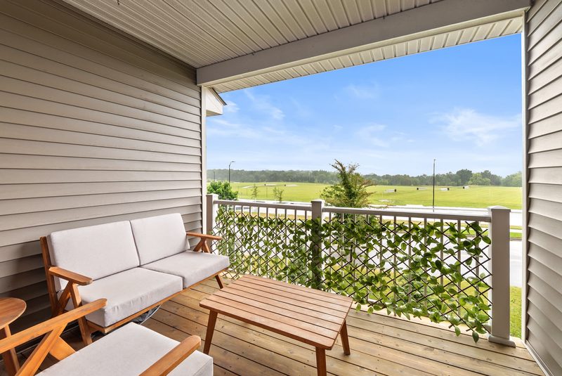 A covered deck looking out over a field